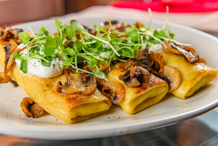 Nubo’s Ukrainian-style crepes are served with savory fillings, reflecting the café’s focus on comfort food prepared fresh from simple ingredients.