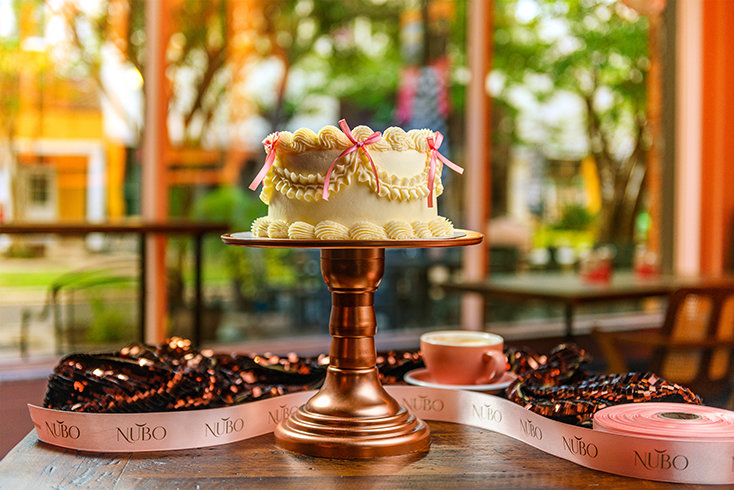 A decorated cake is displayed inside Nubo Café & Bakery, where handmade desserts and fresh pastries are part of the café’s from-scratch approach.