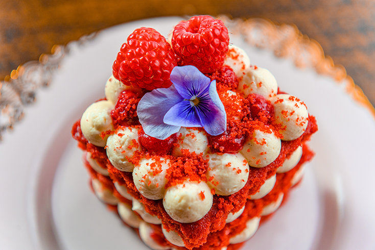 A red velvet cake showcases Nubo’s colorful dessert selection, prepared in the café’s in-house bakery.