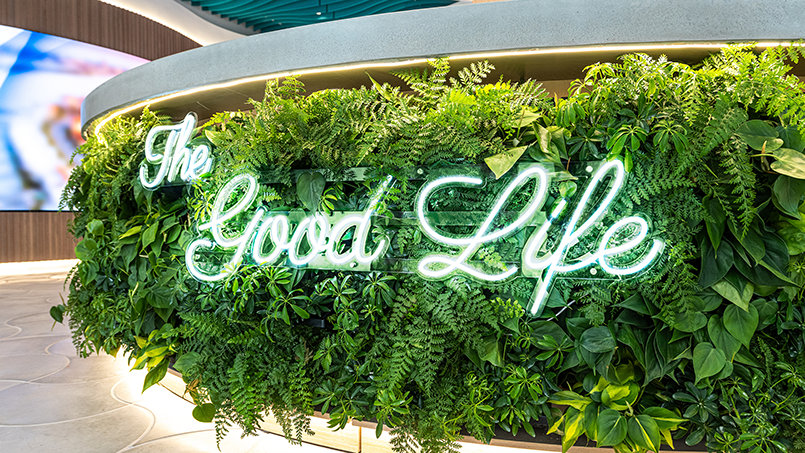 Set against a living wall of greenery, The Good Life sign reflects the energy and forward momentum shaping downtown Clearwater.