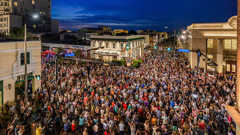 More than 3,000 people fill the intersection of Cleveland Street and Fort Harrison Avenue to celebrate the completion of the Peoples Bank restoration and the return of its historic four-faced clock—marking another milestone in the continuing revitalization of downtown Clearwater.