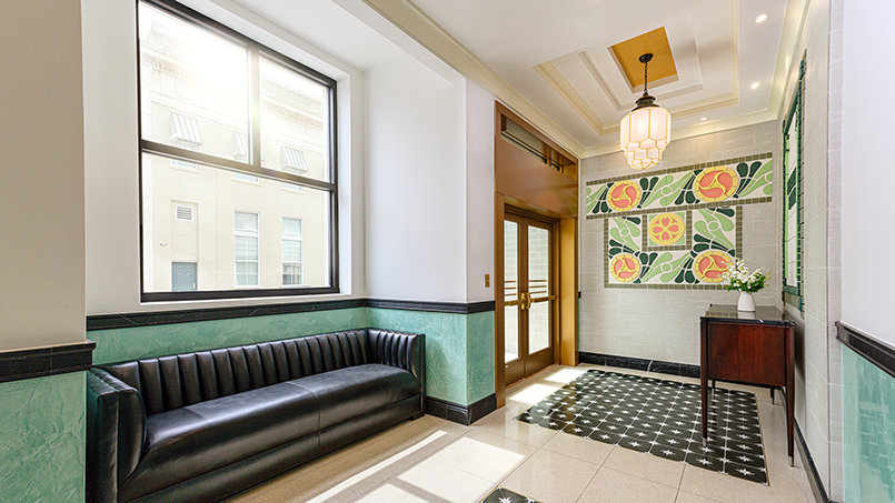 Venetian plaster, Mediterranean Revival tilework, brass hardware and restored architectural detailing reflect the thoughtful craftsmanship that guided the Peoples Bank restoration.