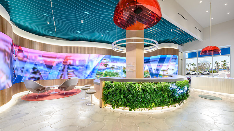 A 56-foot ribbon-shaped LED installation anchors the showroom, presenting a continuous visual narrative of Clearwater’s evolution.