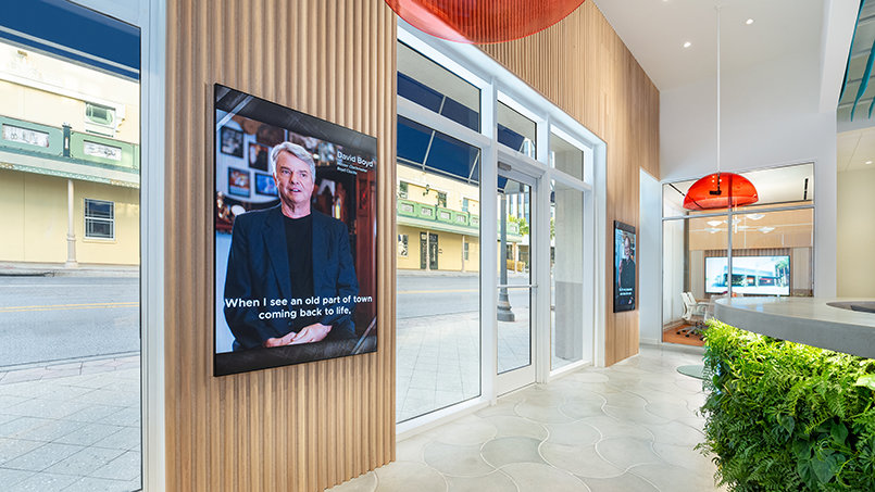 Portrait video stations with directional audio present firsthand accounts of the Cleveland Street initiative, creating a focused and individualized viewing experience.