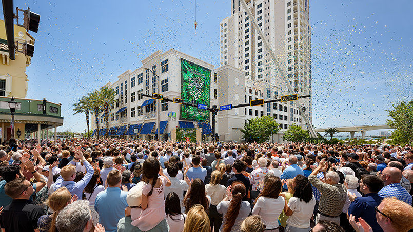 Attendees pack the intersection outside 331 Cleveland Street for the opening of the Cleveland Street Alliance’s showroom, where the district’s revitalization takes physical form.